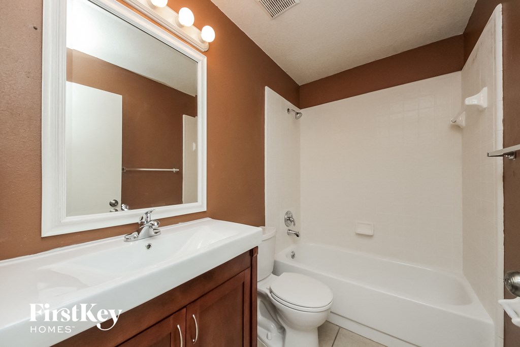 a bathroom with a sink and a toilet and a bath tub