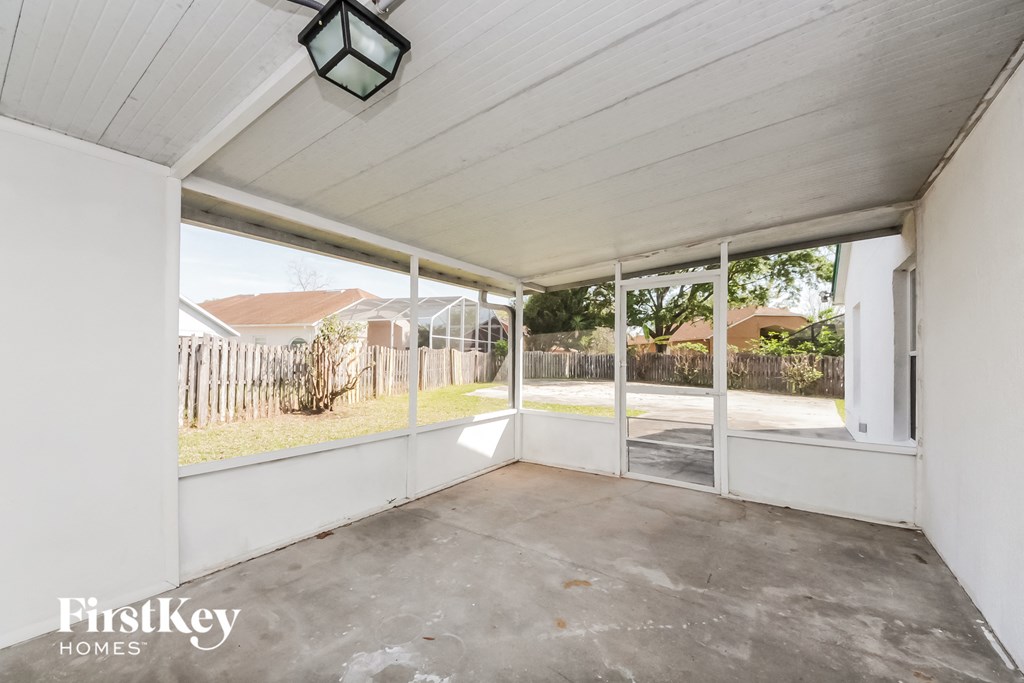 a patio with glass doors and a white porch