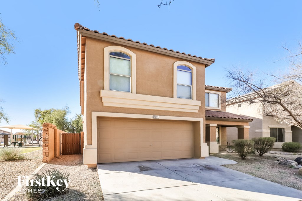 a house with a garage door and a driveway
