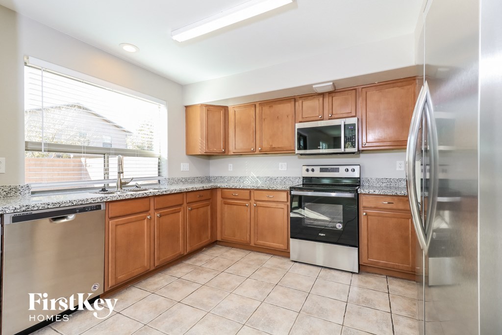 a kitchen with wooden cabinets and stainless steel appliances