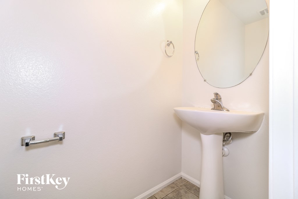 a small bathroom with a sink and a mirror