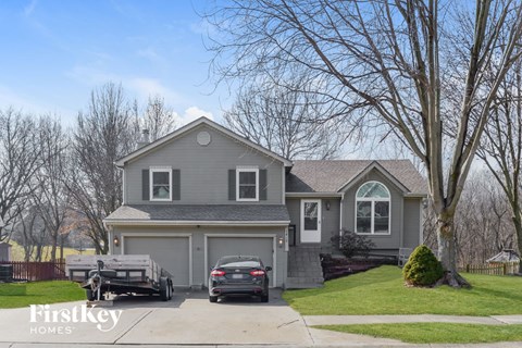a with two cars parked on the driveway
