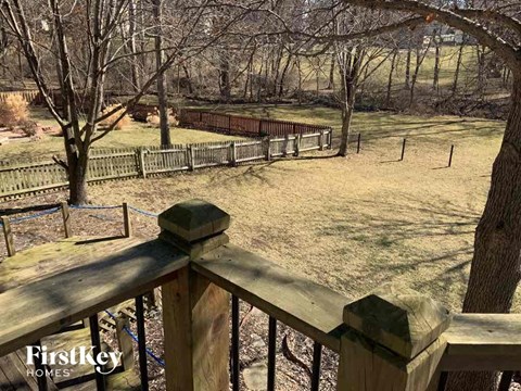 a view of a dog park from a wooden fence