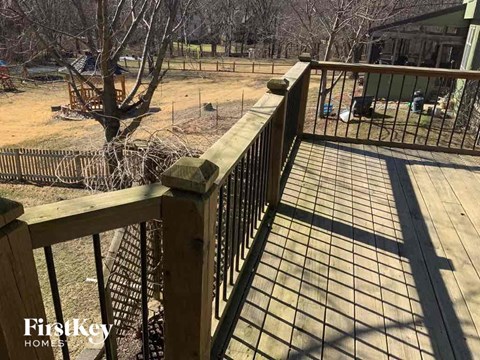a wooden fence with a black wrought iron gate