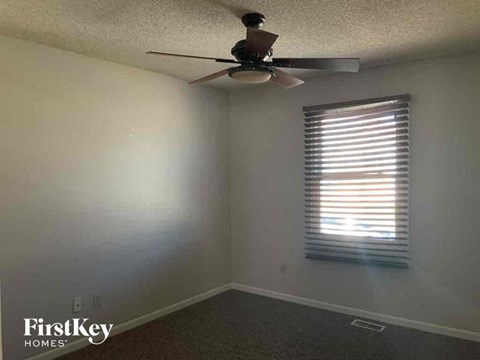 a room with a ceiling fan and a window