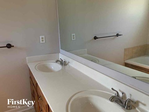 a bathroom with two sinks and a large mirror