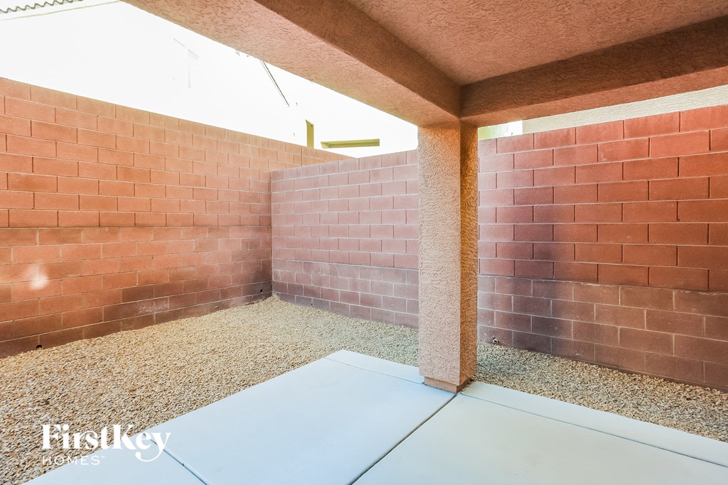a room with a concrete floor and brick walls