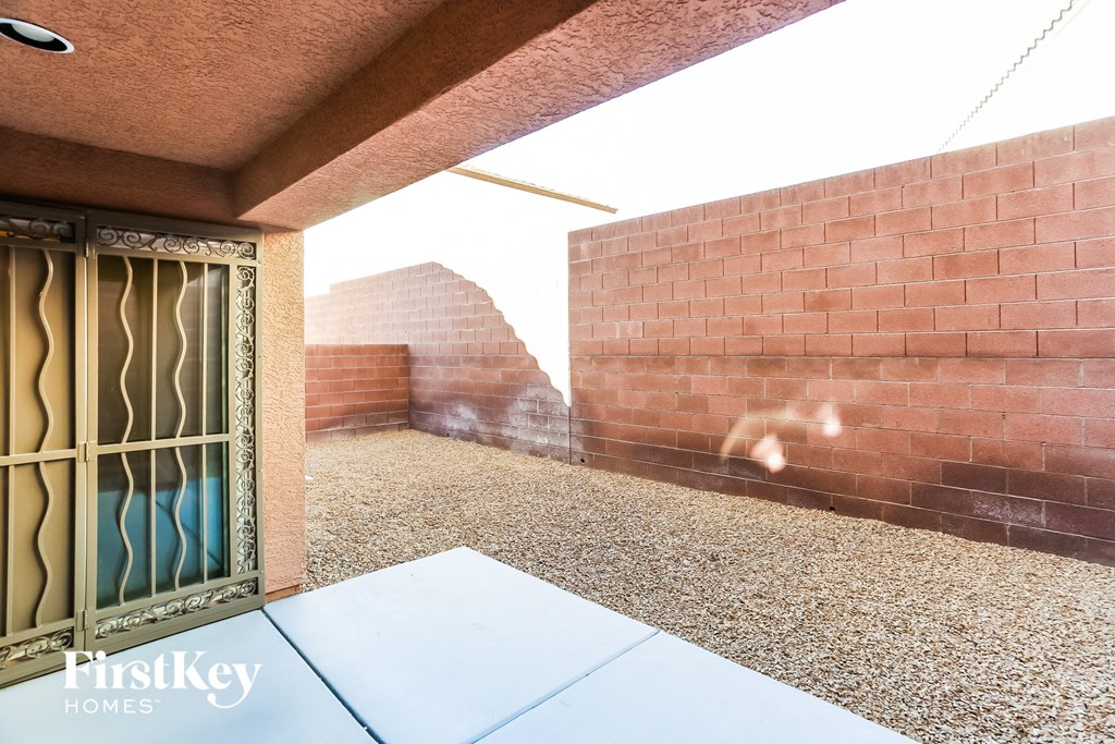 a patio with a door and a brick wall