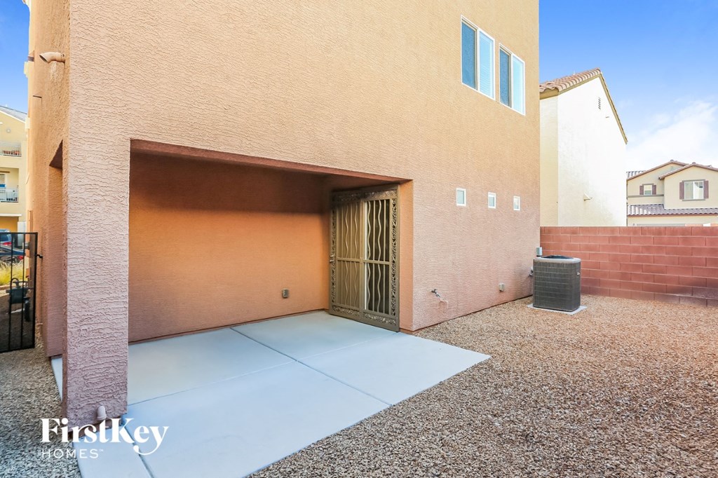 a garage door of a brick house with a trash can