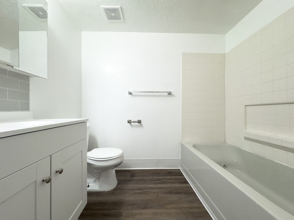 an empty bathroom with a toilet and a bath tub
