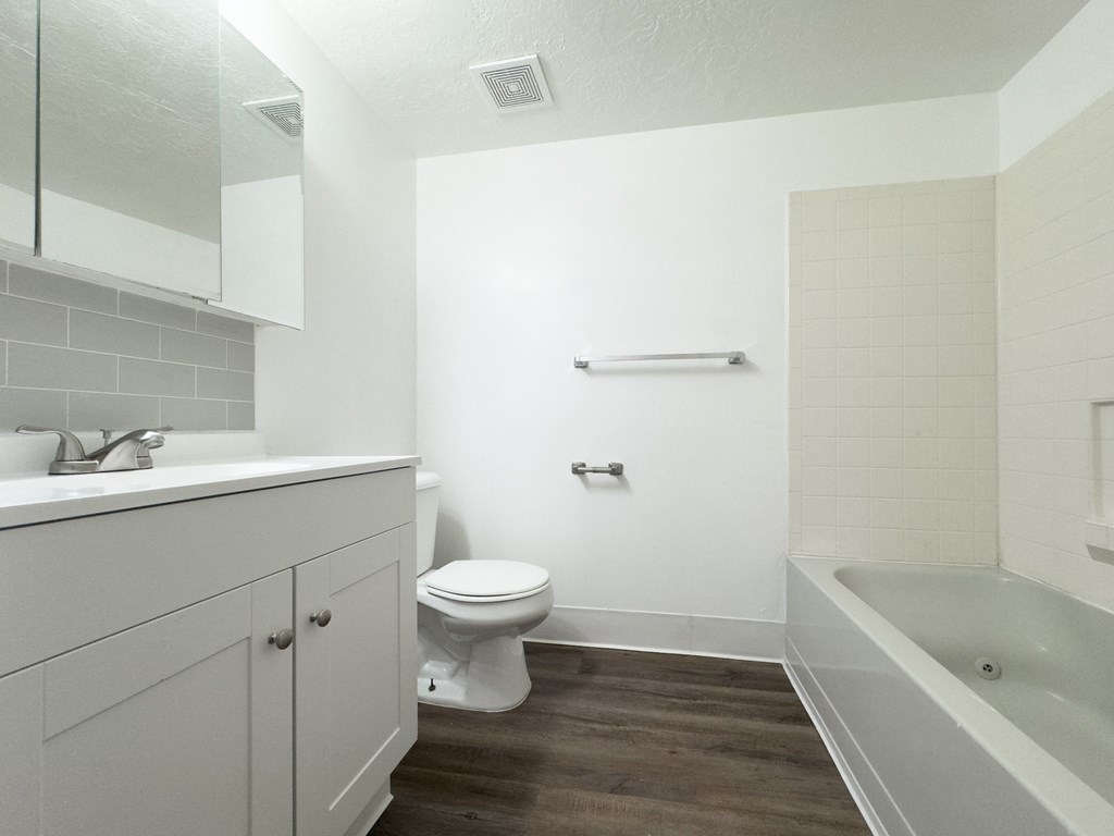 an empty bathroom with a toilet and a bath tub