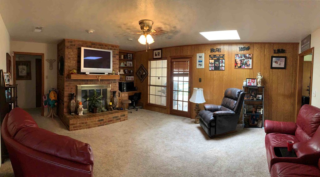 a living room with a fireplace and leather furniture