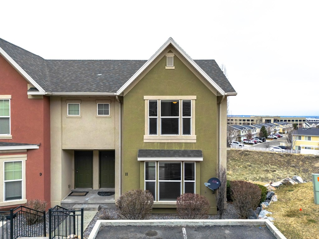 the front of a house with the ocean in the background