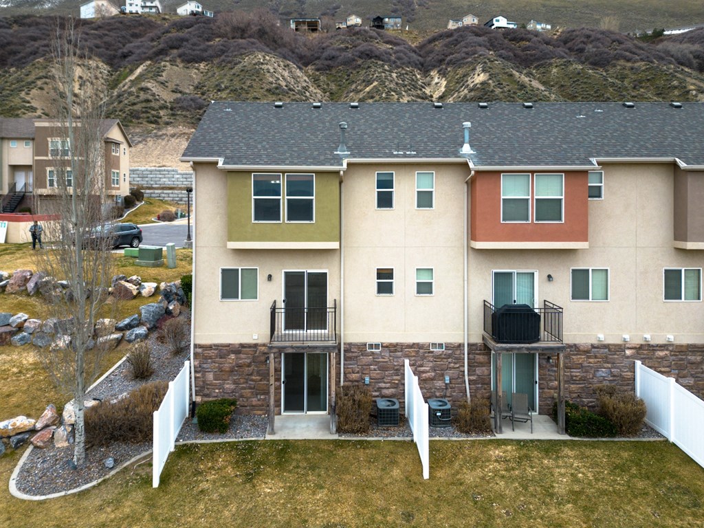 an aerial view of a house with a yard and a fence