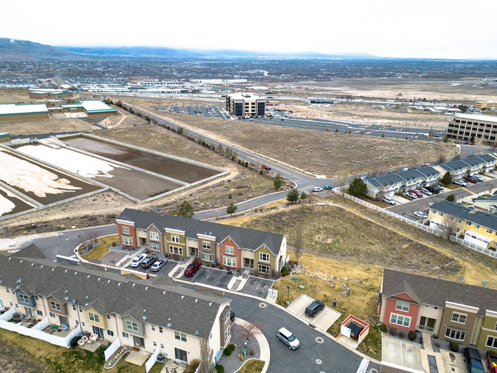 an aerial view of a city with houses and a parking lot