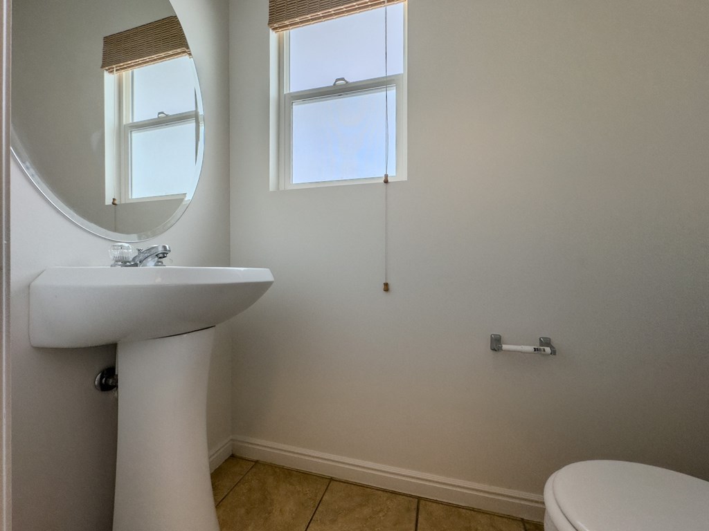 a small bathroom with a sink and a mirror and a toilet