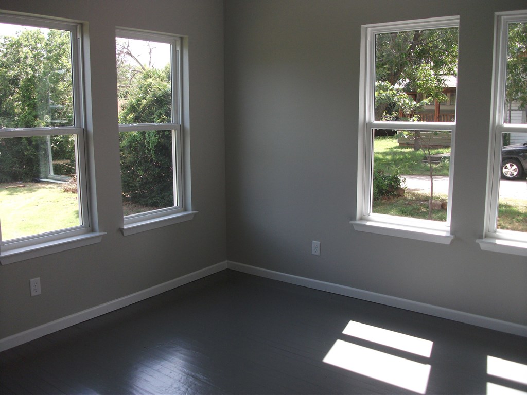 an empty room with three windows in it
