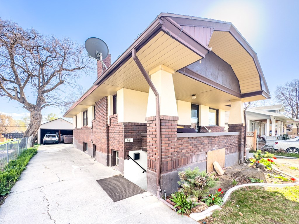 the front of a brick building with a satellite dish on the roof
