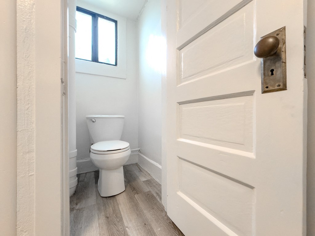 an open door leading to a bathroom with a toilet