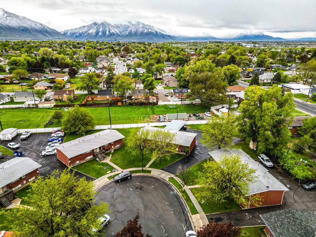an aerial view of a city with mountains in the background