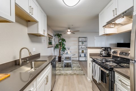 A modern kitchen with a stainless steel sink and refrigerator.