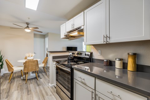 A modern kitchen with a dining table and chairs.