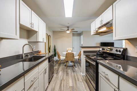 A modern kitchen with a dining area in the middle.
