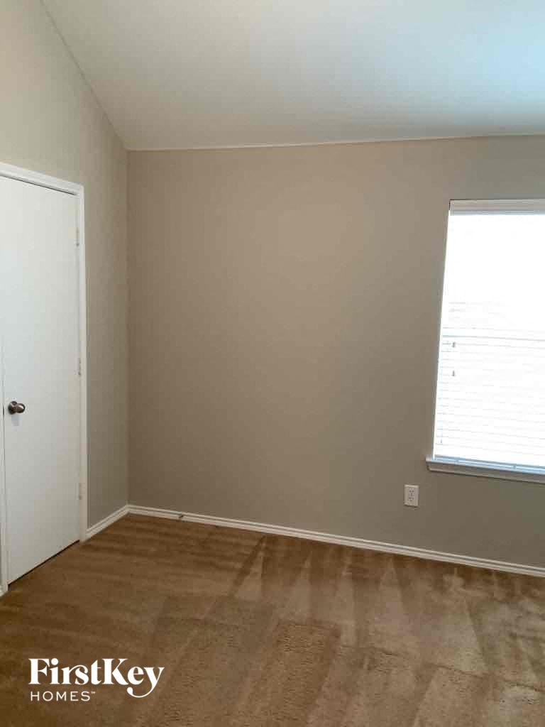 an empty room with a door and a window