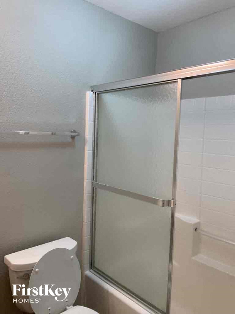 a bathroom with a shower and a toilet