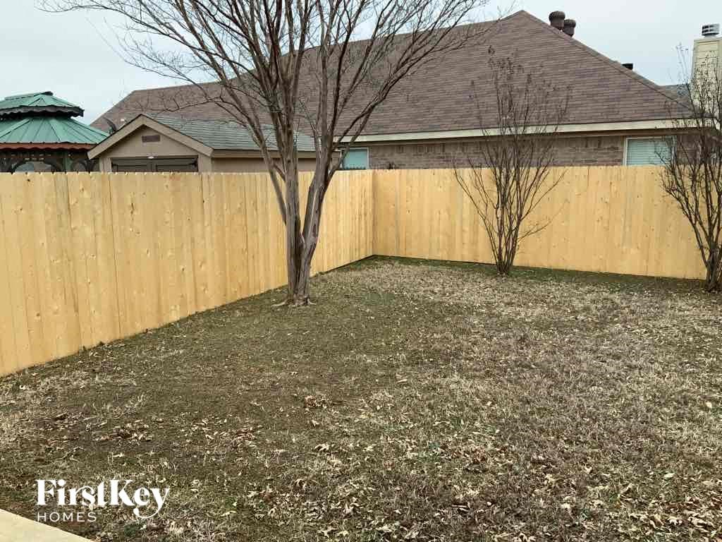 a wooden fence in front of a house