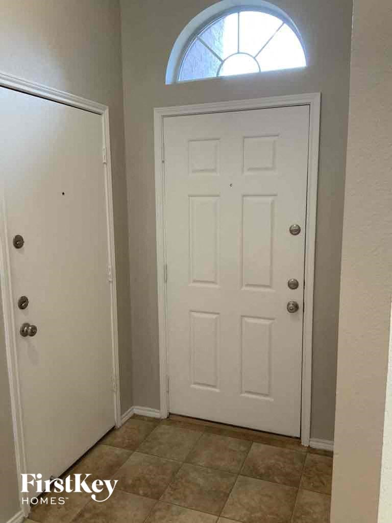 a white door with a window above it and a closet