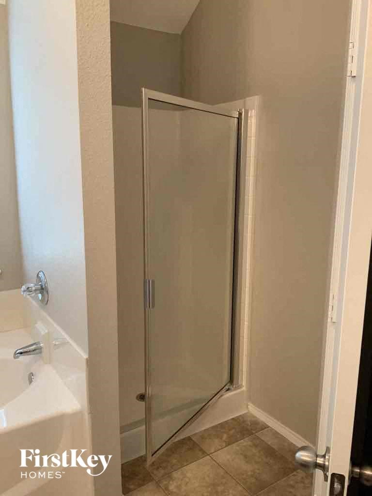 a small bathroom with a shower and a sink