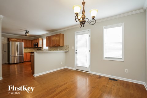 A kitchen with wooden cabinets and a refrigerator.