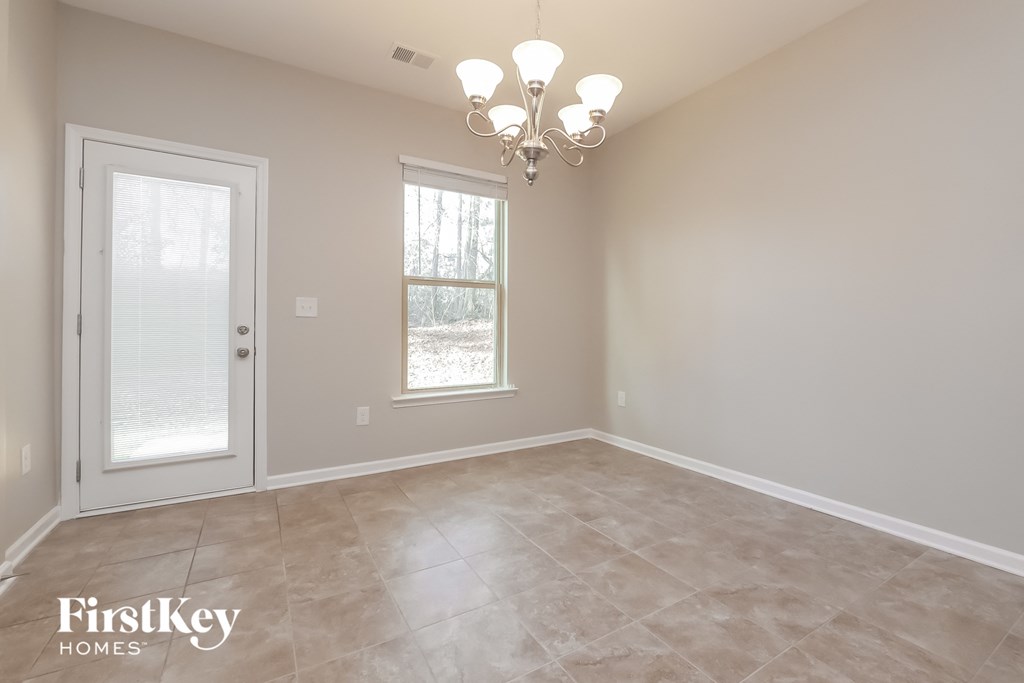 the dining room of a home with a chandelier