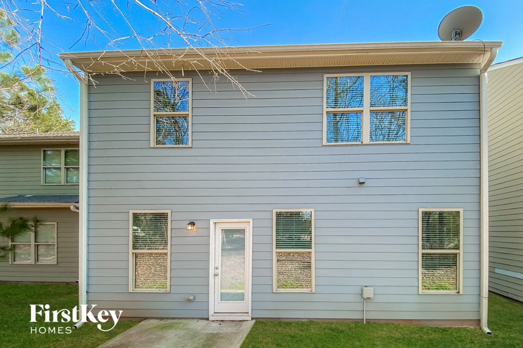 a blue house with a door and a satellite dish on top of it