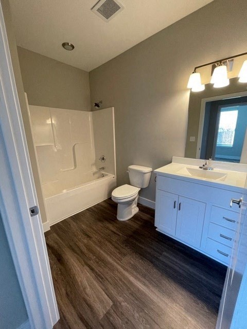 a bathroom with a toilet and a sink and a tub