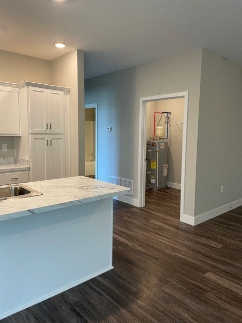 an empty kitchen with a sink and a counter top
