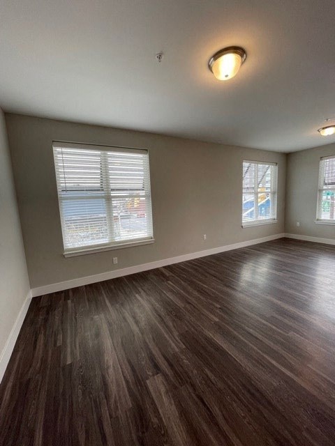 an empty living room with a hard wood floor