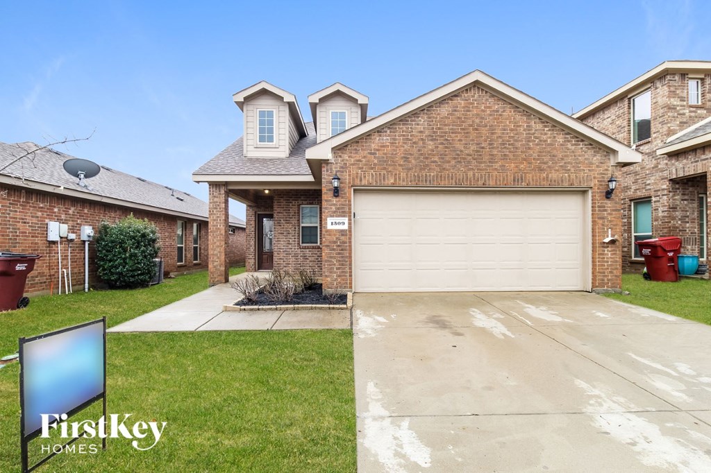 a house with a garage and a driveway in front of it