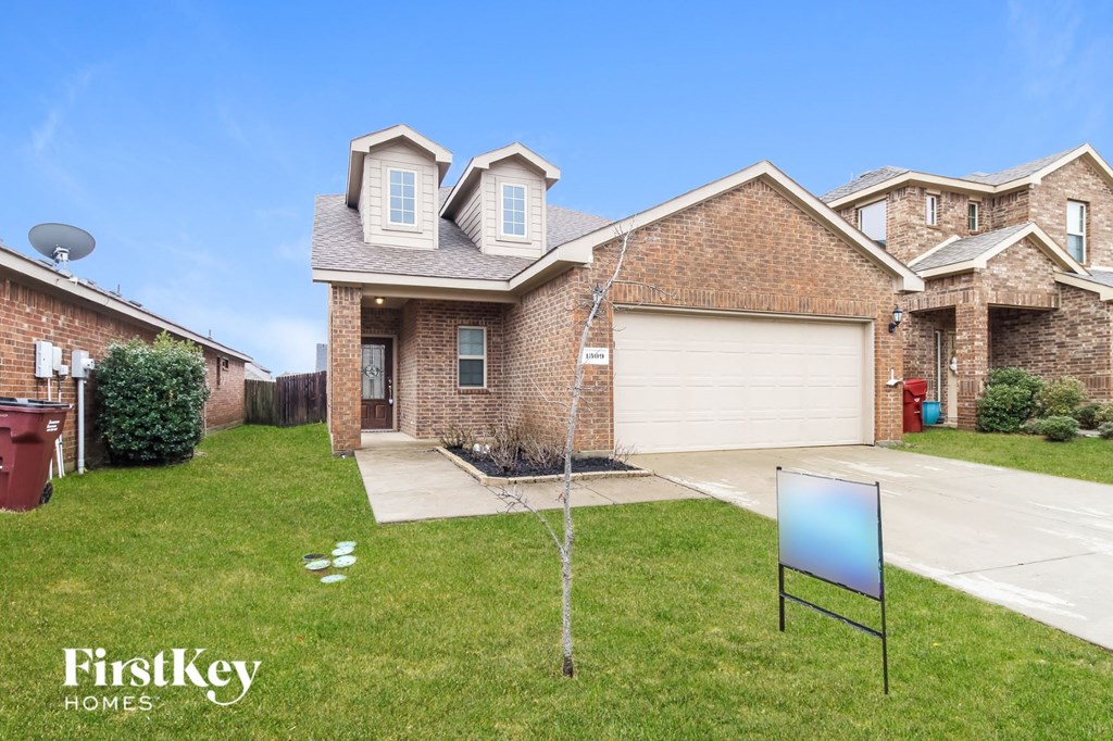 a home with a blue sign on the lawn in front of it