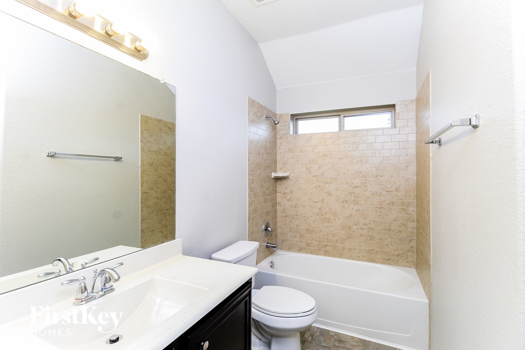 a bathroom with a sink toilet and a tub
