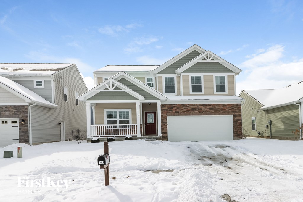 a house with snow in front of it