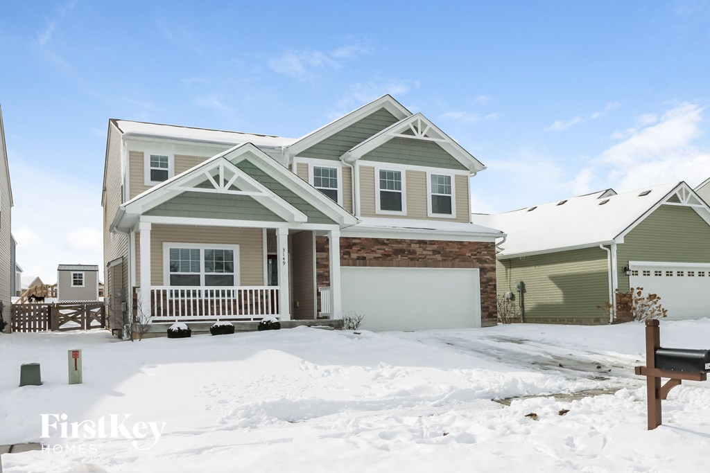 a house with snow in front of it