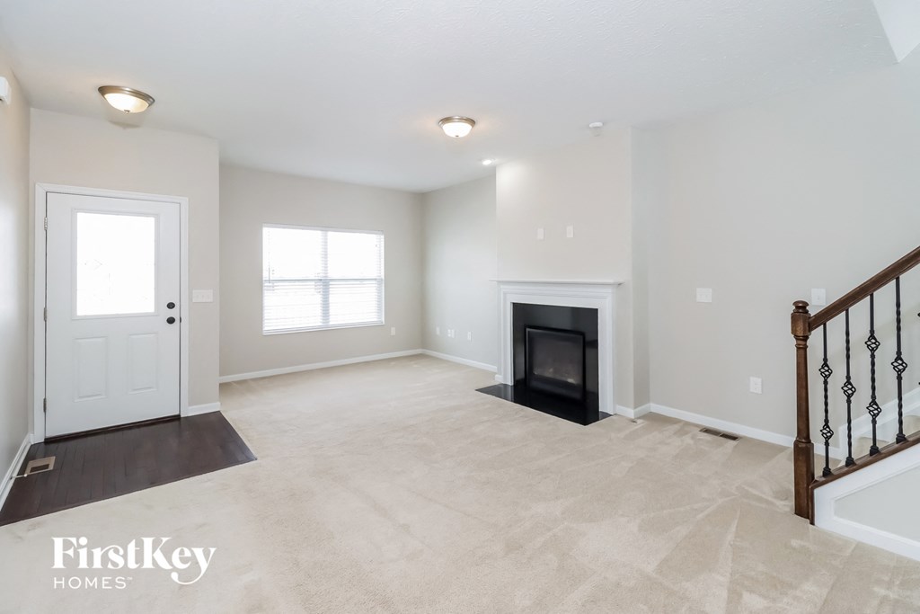 the living room has a fireplace and tile flooring