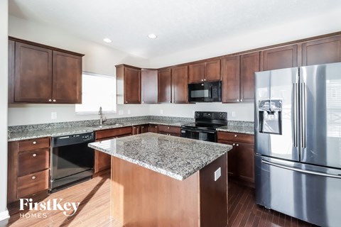 a kitchen with stainless steel appliances and granite counter tops