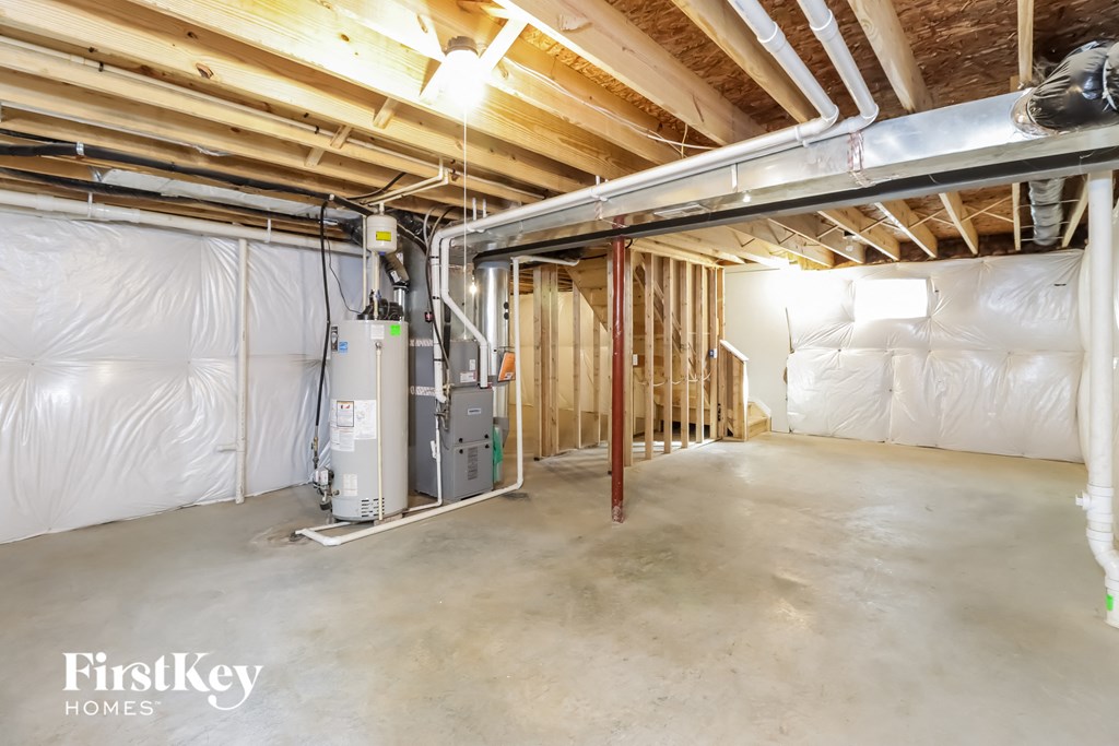 a garage with insulation on the walls and a water heater in it