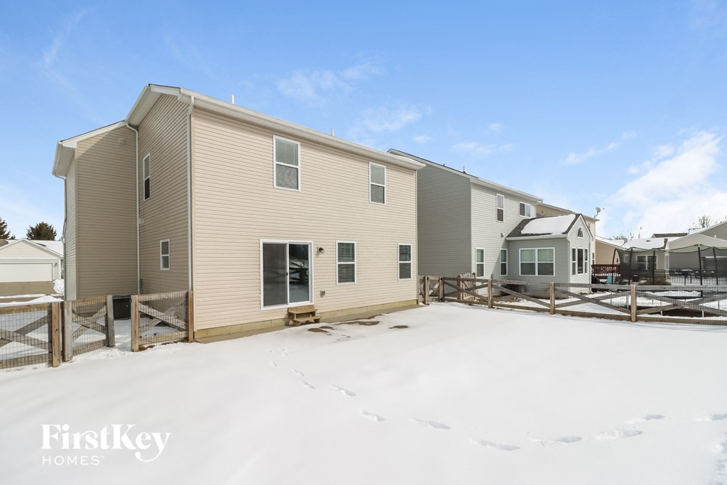 a home with a yard covered in snow