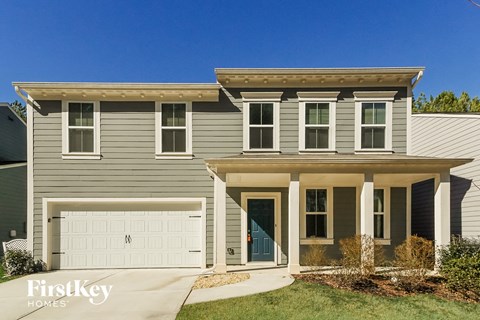 a blue house with a white garage door