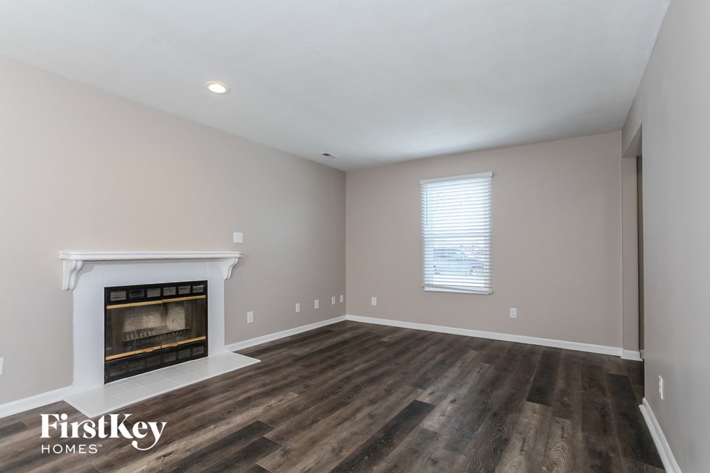 the living room with fireplace and hardwood floors