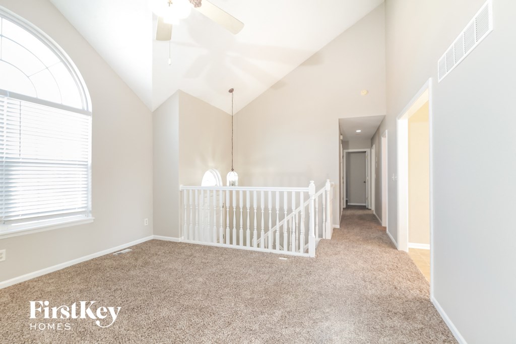 a nursery with a white crib and a hallway with a large window